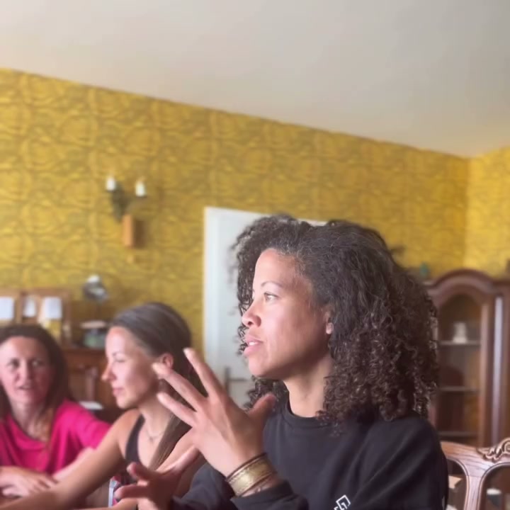 Davina opowiada przy stole pełnym kobiet